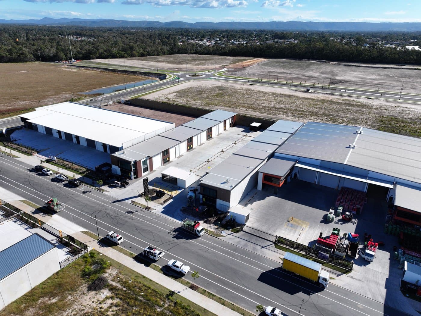 Aerial view of the completed Ellevation industrial estate at North Harbour, Morayfield, with sealed and line-marked hardstand across both unit rows